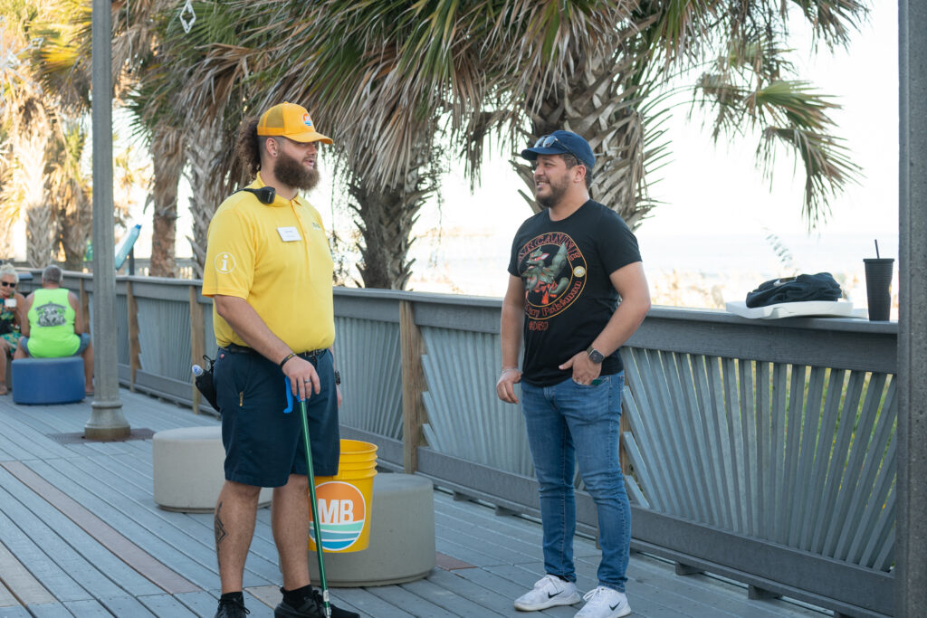 Gold Cap Ambassador Assisting Resident on the Boardwalk